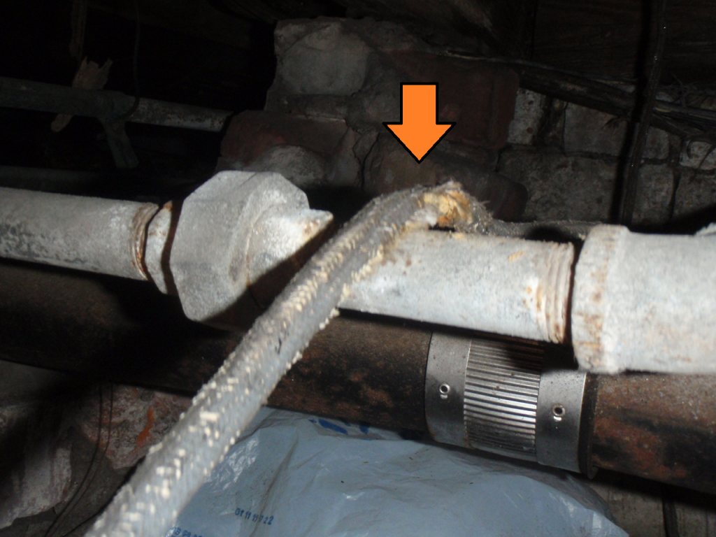 Cloth-covered wiring viewed in a crawlspace during a home inspection